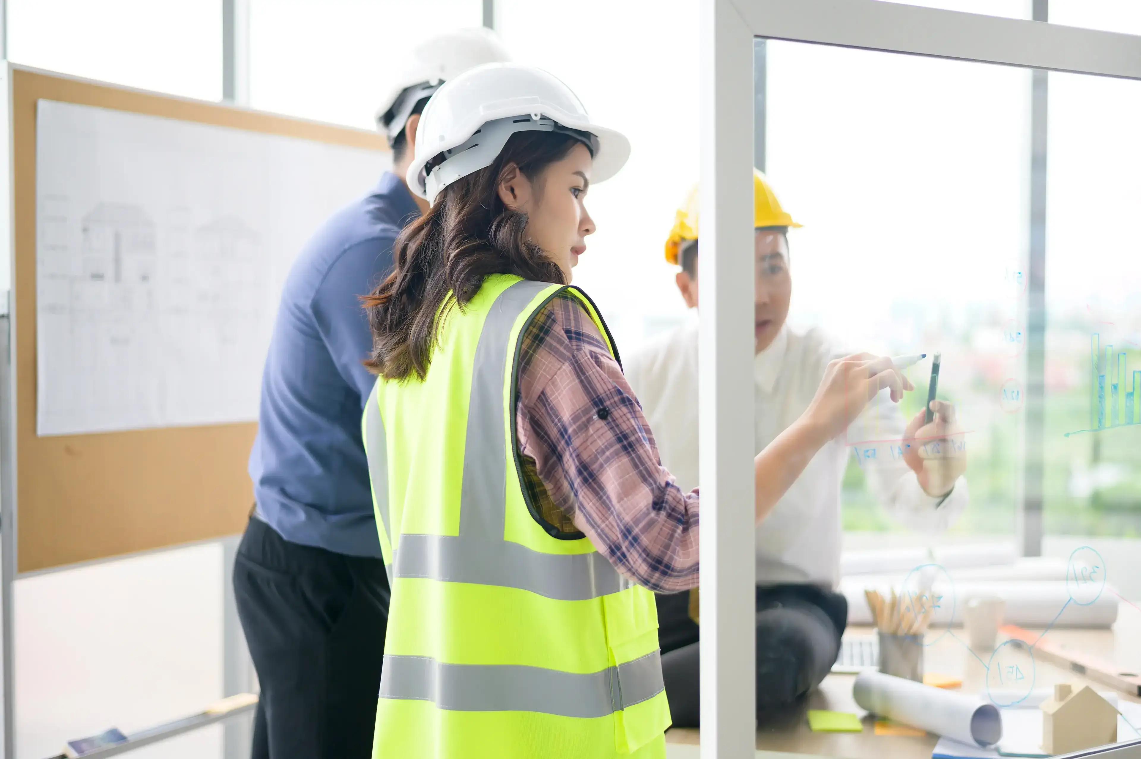 Engineer people plan on glass board
