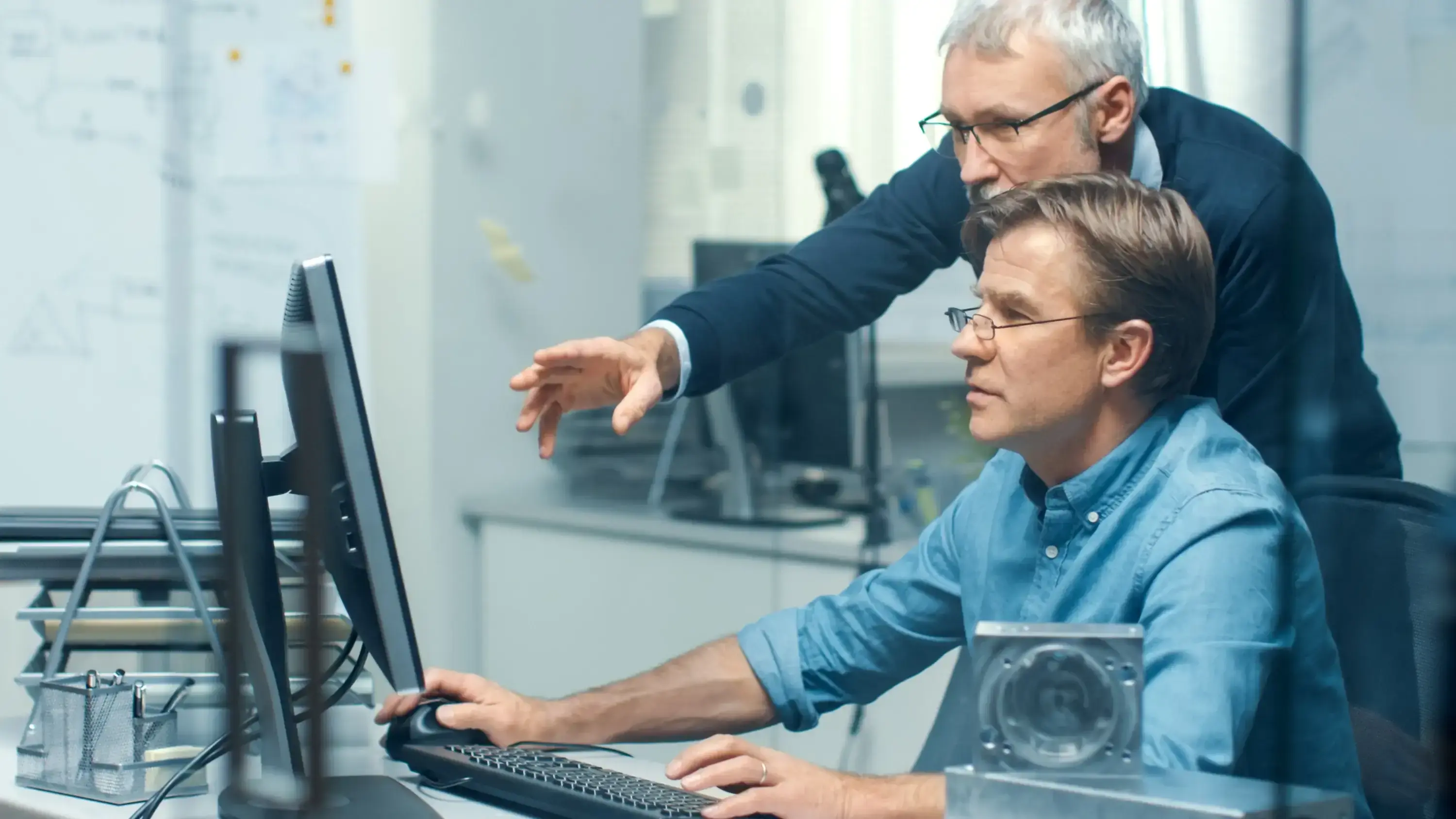 Two senior engineers at desk